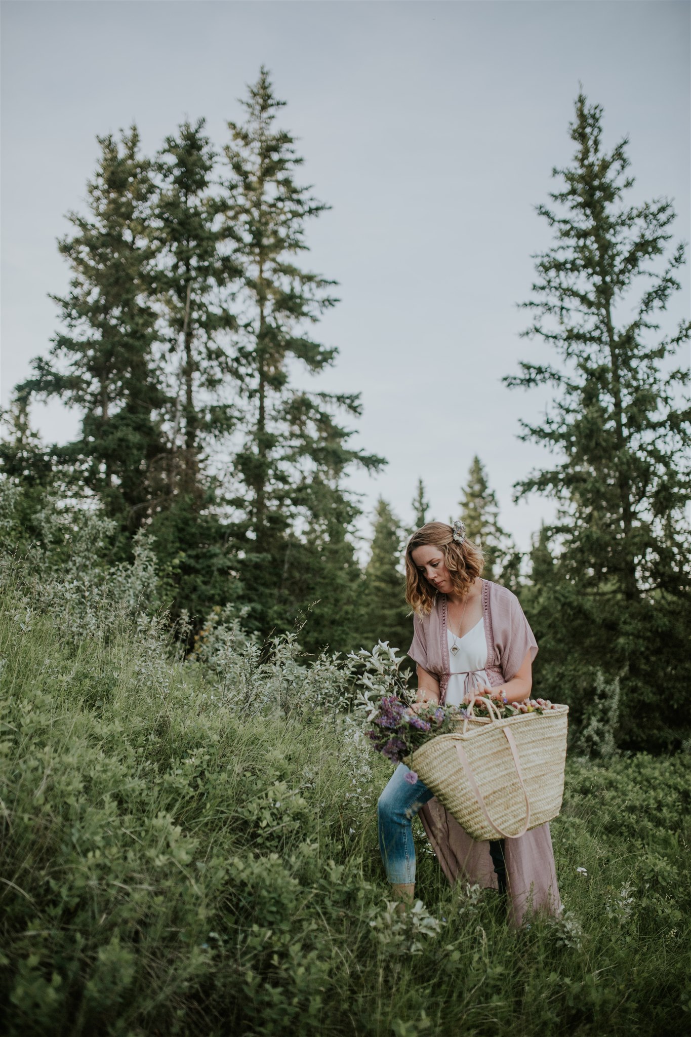 A portrait-oriented image featuring a person holding a basket in a natural setting