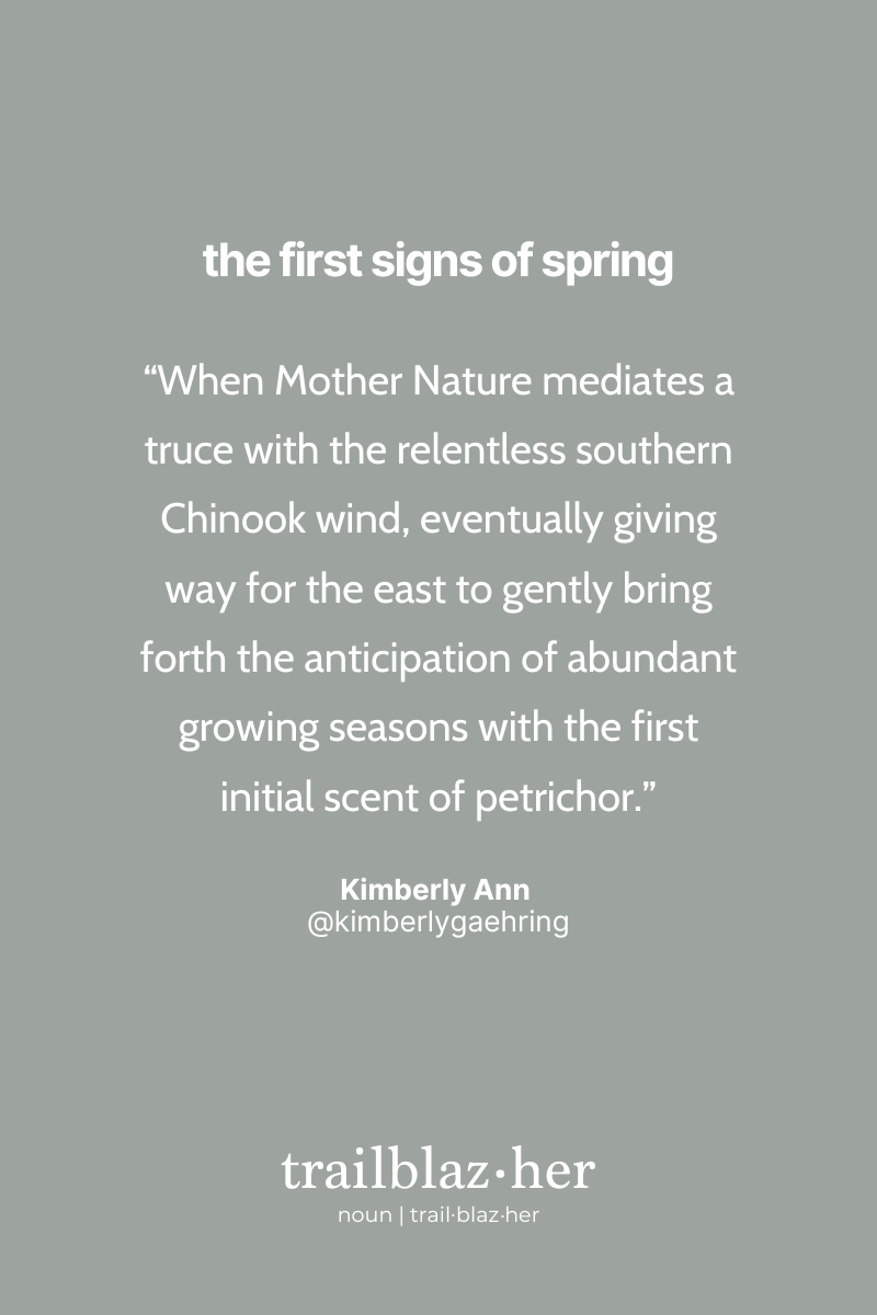 A minimalist graphic with a taupe background featuring text that reads "the first signs of spring" at the top. A quote by Kimberly Ann is centered on the page, reflecting on the delicate balance of nature and the first scent of petrichor signaling the start of the growing season. At the bottom, the word "trailblaz.her" is defined as a noun.