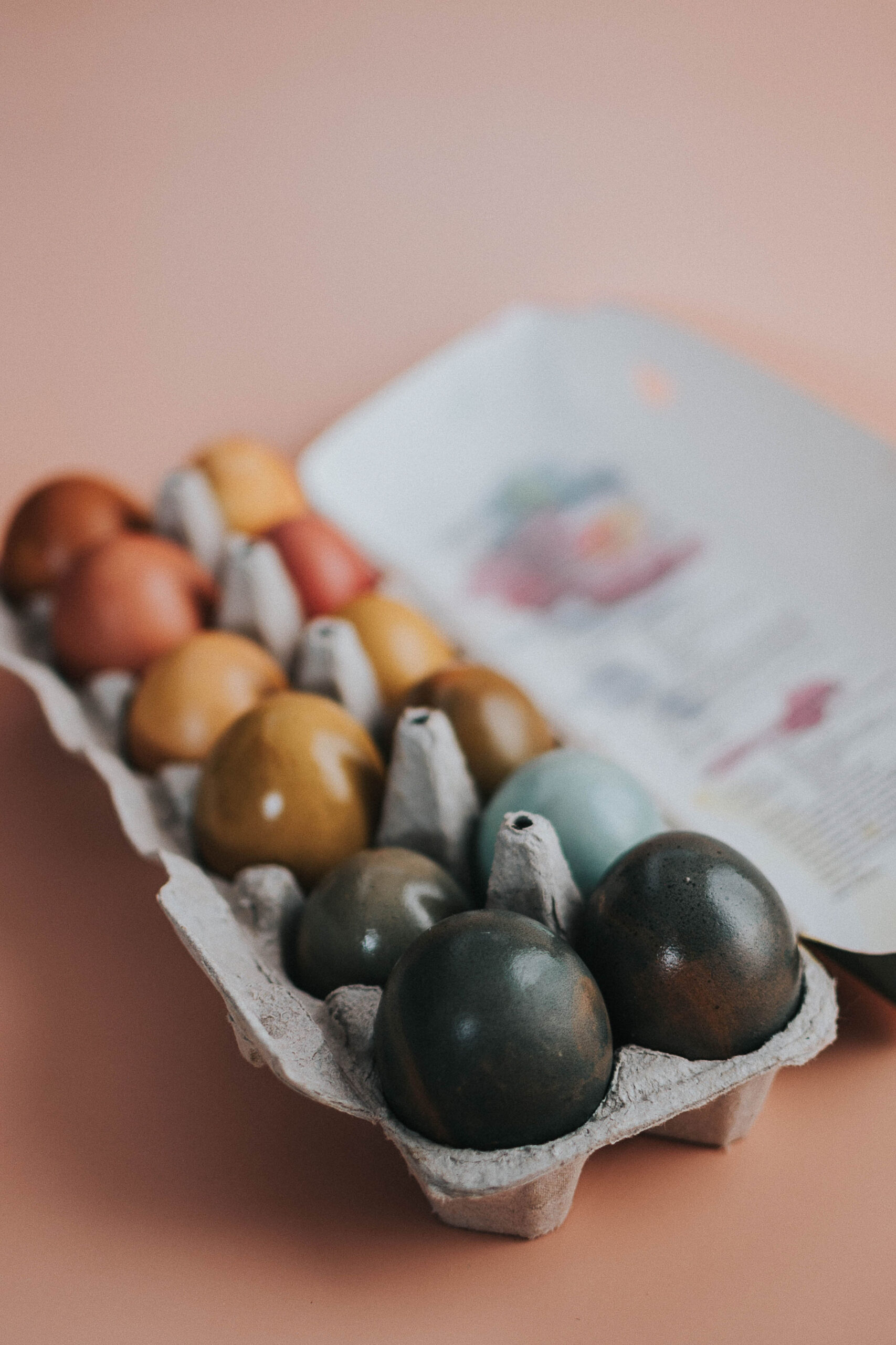 naturally dyed eggs in an egg carton