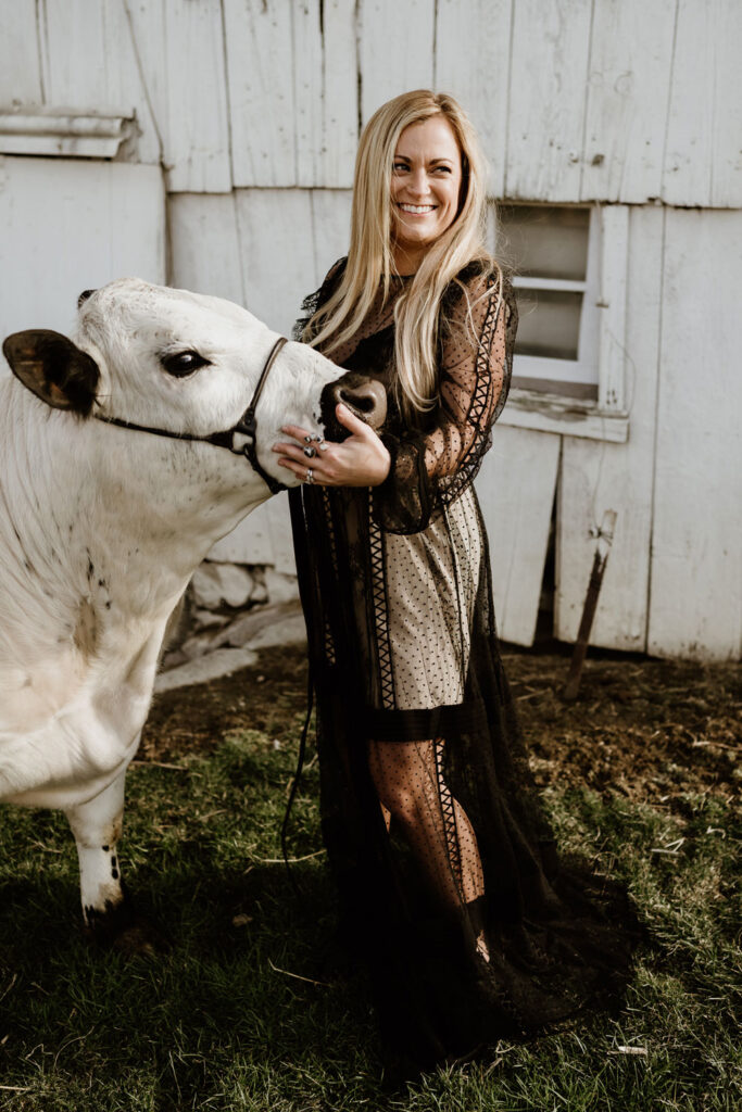 Marissa stands with a white cown wearing a black dress